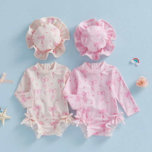 Maillot de bain pour bébé fille, protection contre les éruptions cutanées, imprimé nœud, à volants, manches longues, col rond, vêtements de plage, combinaison et chapeau, ensemble 2 pièces